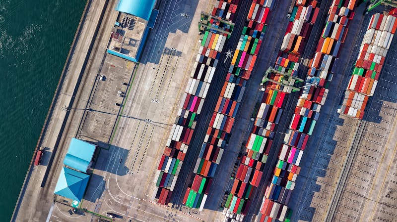 Aerial view of a busy ocean port with container ships