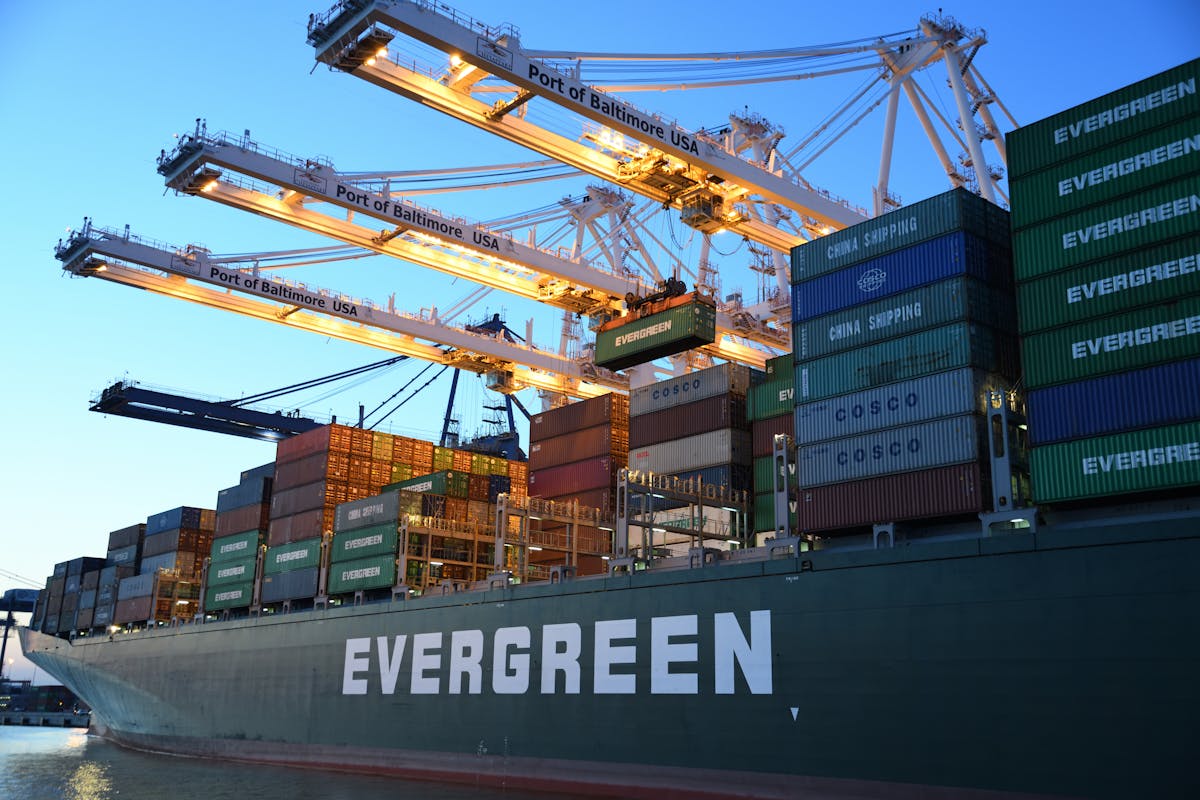 Container ship at port being loaded with cargo